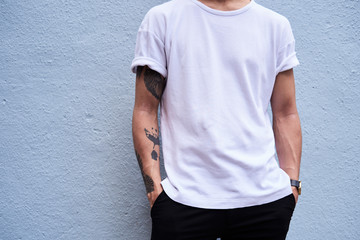 Young man with tattooed arm, partial view