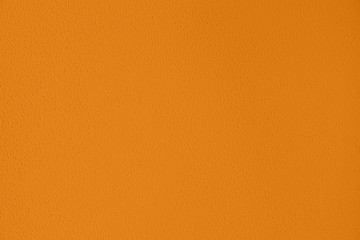 Saturated dark yellow colored low contrast Concrete textured background with roughness and irregularities. Autumn Winter 2020 color trend.