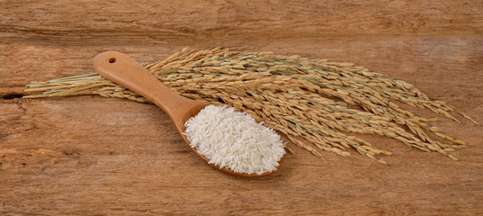 Rice on a wooden spoon on a wooden