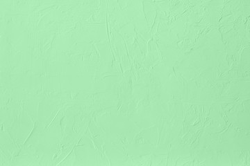 Trendy mint colored low contrast Concrete textured background with roughness and irregularities to your design or product. Year color trend concept.