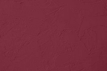 Dark red Concrete textured background to your concept or product. Winter 2020 color trend.