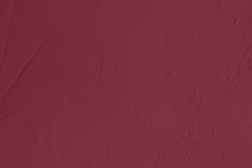 Dark red Concrete textured background to your concept or product. Winter 2020 color trend.