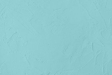 Pale blue colored low contrast Concrete textured background with roughness and irregularities to...
