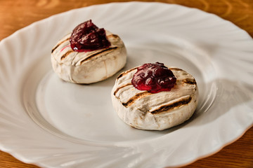 Grilled blue cheese with marmalade on white plate