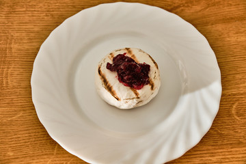 Grilled blue cheese with marmalade on white plate