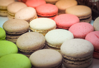 Fototapeta na wymiar Colorful tasty macaroons in a row. Close up and selective focus.