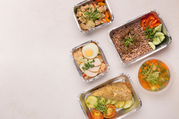 Diversity of Healthy food in foil boxes to go on white