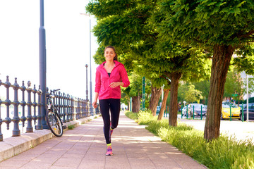 Young woman jogging in the street