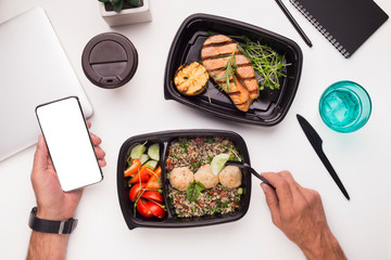 Man eating healthy food preparing on grill on workplace