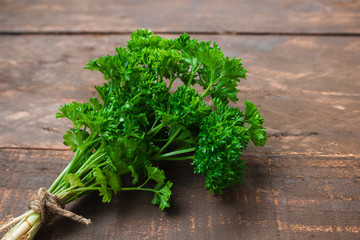 oragnic parsley bunch on wooden table close up