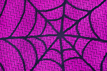 Black cobweb on pink background. Horizontal.