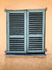 old window with closed shutters
