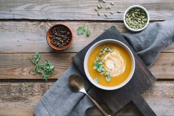 Pumpkin cream soup in bowl. Cooking homemade food. Comfortable seasonal autumn food