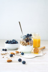 Healthy breakfast in glass jar with yogurt, muesli and blueberries. Healthy food.