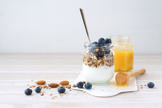 Healthy breakfast in glass jar with yogurt, muesli and blueberries. Healthy food.