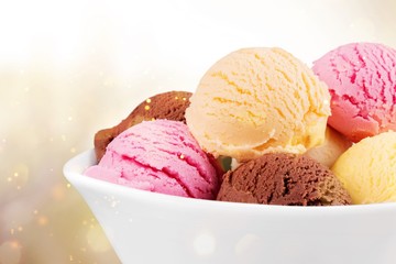 Ice cream scoops in bowl on white background
