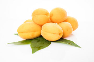 Fototapeta na wymiar Apricot fruit with leaf isolated on white background