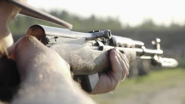 male shoots with a firearm, shotguns outdoors.