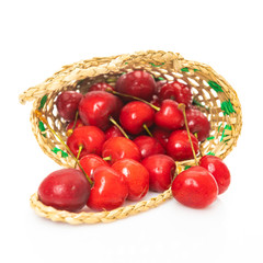 Basket of fresh sour cherries isolated on white