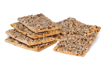 Crispy bread slice with cereals. Healthy cookies with sunflower seeds, flax seeds and sesame seeds.