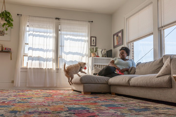 Young woman playing with her dog
