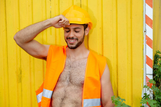 sexy shirtless worker with yellow construction helmet