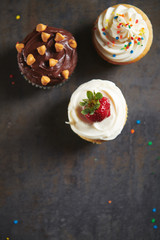 Decorated Cupcakes on Dark Moody Surface