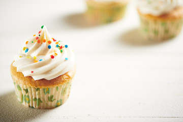 Vanilla Cupcakes on White Surface with Room for Copy