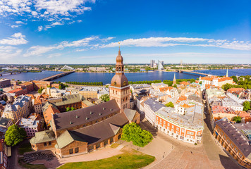 Beautifull aerial panoramic view from drone In sunny summer Day to histirical center Riga and quay of river Daugava. Famous Landmark - City Dome Cathedral church and Old Town Monument. Latvia, Europe.