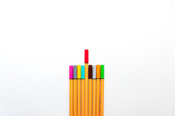 Fototapeta premium colourful markers as a symbol of difference and creativity between individuals with one red marker marker higher than others