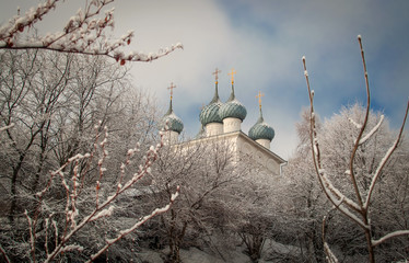 Church in winter on a snow-covered mountain with trees