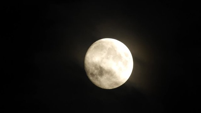 Moon With Clouds In The Night Sky. Concept of a spooky theme and mystery. Mysterious night sky with moon and dramatic clouds passing. Dark night with moon.