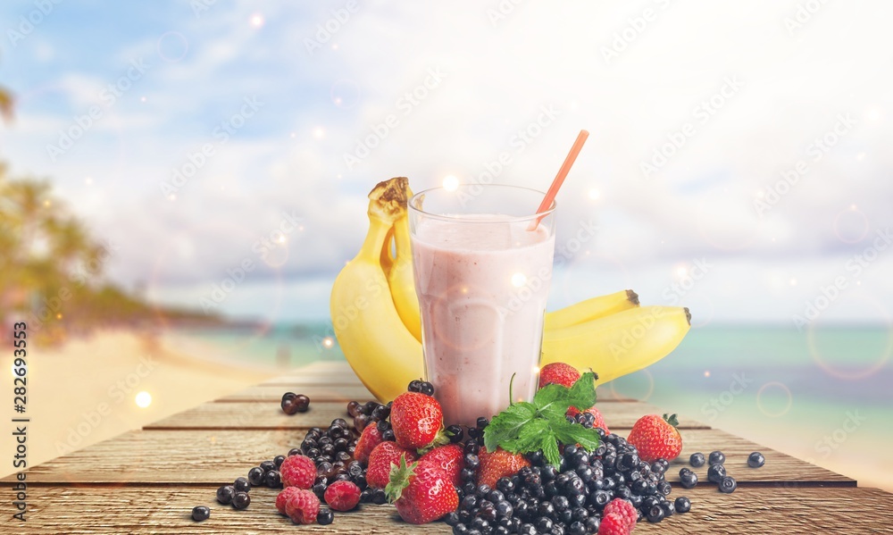 Poster Healthy Fruit Smoothie in glass on wooden table Background