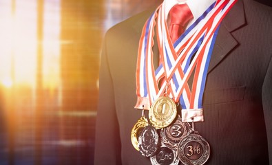 Businessman wearing formal suit and sport medals on background