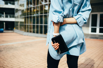 Rear view young woman wearing blue denim shirt