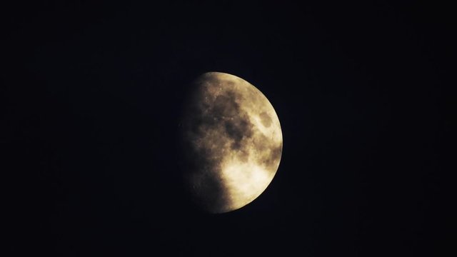 Moon With Clouds In The Night Sky. Concept of a spooky theme and mystery. Mysterious night sky with moon and dramatic clouds passing. Dark night with moon.