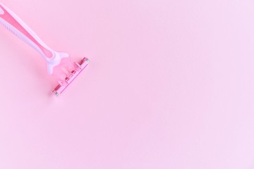 New pink disposable razors for safe shaving of female skin with selective focus on pink background with copy space. Razor for smooth shaving. Sharp razors for personal hygienic routine 