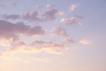 pastel yellow pink cumulus clouds background