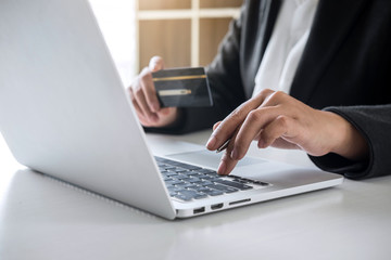 Fototapeta premium Business woman consumer holding credit card and typing on laptop for online shopping and payment make a purchase on the Internet, Online payment, networking and buy product technology