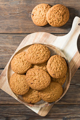 Oatmeal cookies in a wooden plate on a wooden table. rustic style