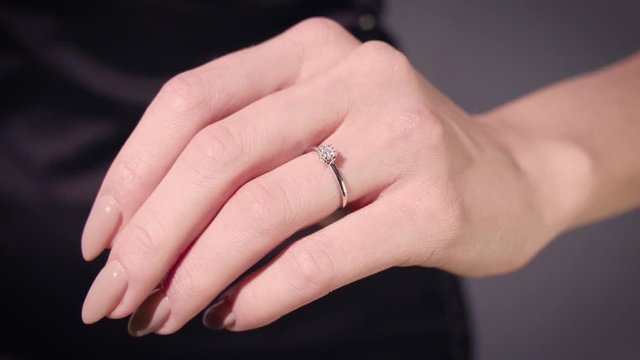 Woman surprises with her diamond engagement ring. Wedding ring jewelry