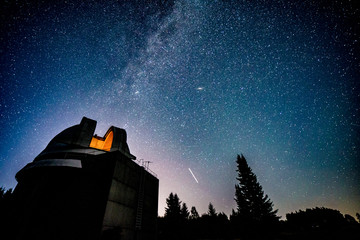 Milky way galaxy over observatory - Powered by Adobe