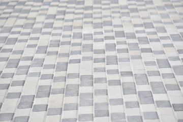 the ground of white and grey tiles