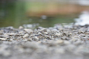 stones on the riverbank near the waterline