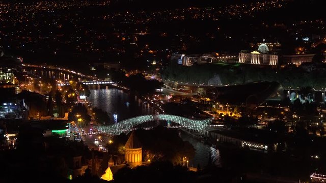 Overview of the Piece Bridge on Mtkvari (Kura) River at night. Tbilisi, Georgia.