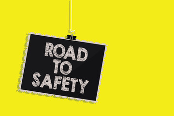 Writing note showing Road To Safety. Business photo showcasing Secure travel protect yourself and others Warning Caution Hanging blackboard message communication sign yellow background