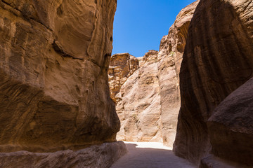 Fototapeta premium The stone walls of the narrow passage (Siq) that leads to Petra in Jordan
