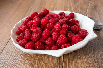 Fresh raw organic raspberries on a plate