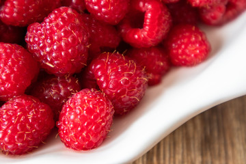 Fresh raw organic raspberries on a plate