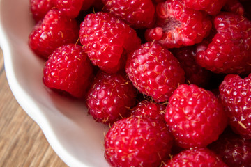 Fresh raw organic raspberries on a plate